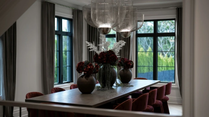 Elegant dining room with large table and red chairs